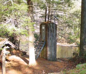 Photograph of a USGS streamgaging station in a forested area.