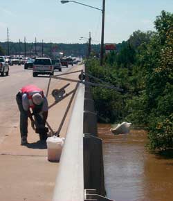 Photograph of USGS scientist processing a water-quality sample collected from the Tar River.